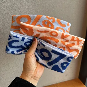 Set of elastic knitted sports headbands with colorful geometric patterns and digits