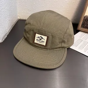 Detailed close-up of a 5-panel camper hat with outdoor wild life adventure patch