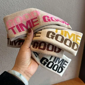 Fasce sportive in maglia con scritta GOOD TIME nei colori rosa, marrone, giallo e nero
