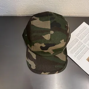 Flat brim camouflage 5-panel camp hat featuring vintage street style and metal side eyelets