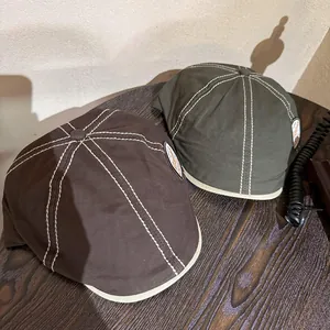 Retro canvas newsboy caps in dark coffee and olive green with contrast white stitching