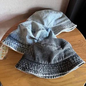 Vintage washed denim bucket hats in multiple colors with frayed edges and retro style