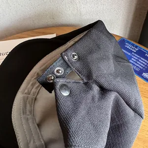 Detailed close-up of dark grey twill cap with adjustable double-row metal buckles