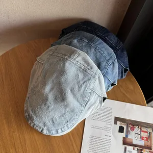 Three denim ivy caps with quilted texture in light, medium, and dark blue washes