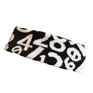 Breathable black and white knitted sports headband featuring abstract jacquard number patterns