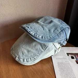 Detailed view of vintage denim newsboy caps with subtle textured jacquard patterns