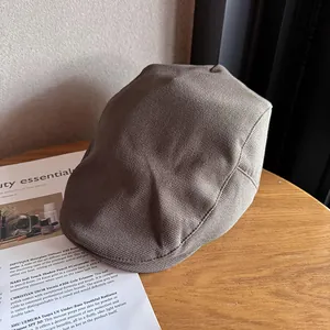 Detailed texture of a brown newsboy cap in thick twill fabric for vintage autumn style
