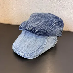 Close-up of vintage washed denim berets showing distressed texture and stitching