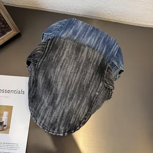 Detail of vintage denim flat caps in grey and blue with washed twill texture