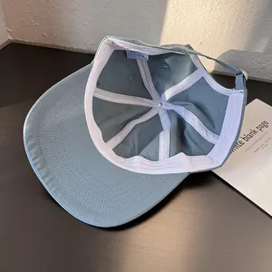 Detail view of cotton baseball cap interior featuring white sweatband and metal buckle