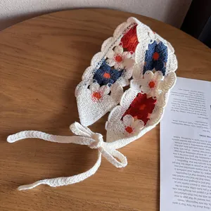 Close-up of handmade crochet flower headband with intricate knit texture and wavy edges