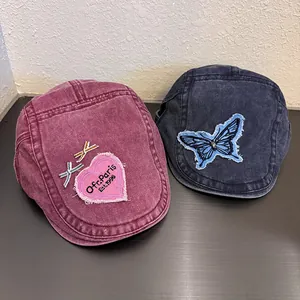 Vintage washed denim newsboy hats with heart embroidery and bow detail in red and navy