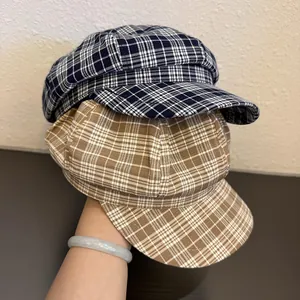 Classic plaid newsboy caps in navy and khaki with octagonal crowns and short brims