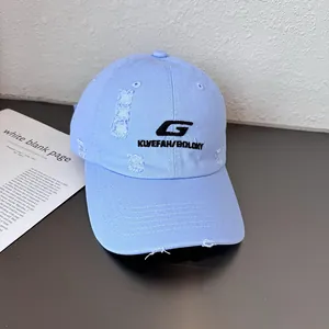 Detailed view of light blue distressed baseball cap with 3D letter G embroidery