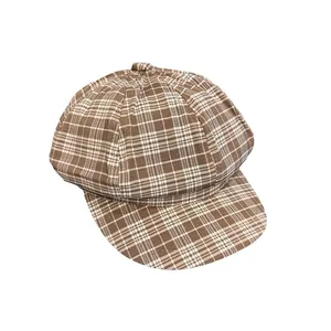 Classic plaid newsboy hat in brown and beige tones, vintage style on a white background