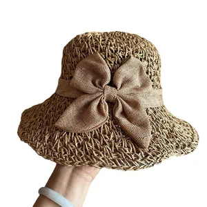 Foldable khaki straw sun hat with decorative linen bow and wide wavy brim for summer