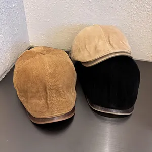 Detail of vintage newsboy hats in corduroy with premium leather brim edge accents
