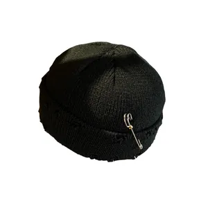 Hip hop black knit beanie with distressed detailing and silver safety pin accessory