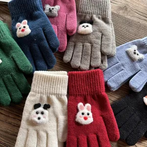 Detail of colorful knitted gloves featuring cute 3D plush animal designs and ribbed cuffs