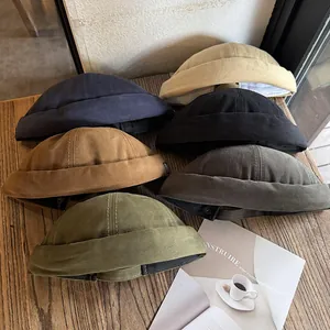 Harajuku style cotton canvas docker caps in six colors displayed on a wooden table
