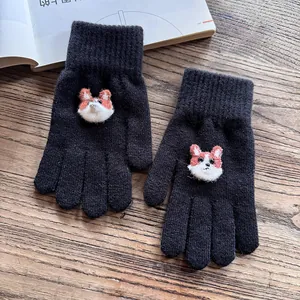 Close-up of black knit gloves featuring cute corgi patches and ribbed windproof cuffs