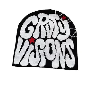 Zwarte gebreide muts met witte graffiti letters en rood jacquard sterpatroon
