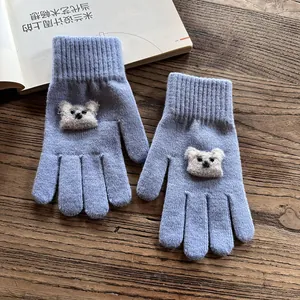 Detail of lavender knit gloves with cute plush koala ornament and ribbed elastic cuffs