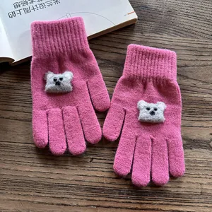 Detail of rose pink knit gloves featuring cute plush koala patches and ribbed cuffs
