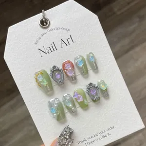 Handmade 3D press-on nails set with star and heart charms on display card