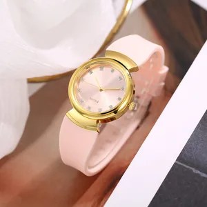 Elegant women's quartz watch with pink silicone strap and crystal markers on gold case