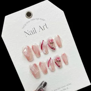 Handmade press-on nails with pink marble texture, 3D red floral art and crystal rhinestones