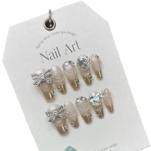 Handmade press-on nails with luxury rhinestones, bow knots and pink gold glitter