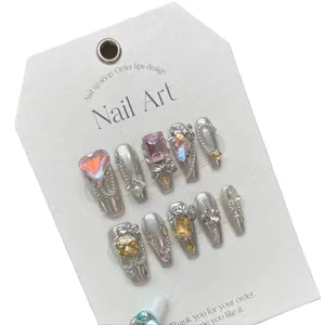 Handmade silver mirror press-on nails with pink heart rhinestones and silver chains