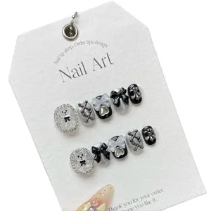 Handmade Y2K black glitter press-on nails featuring 3D bears, bows, and silver gothic charms