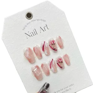 Handmade press-on nails with pink marble texture, red roses and 3D gemstone accents