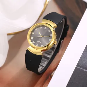 Macro view of crystal markers and golden case on women's quartz watch with black strap