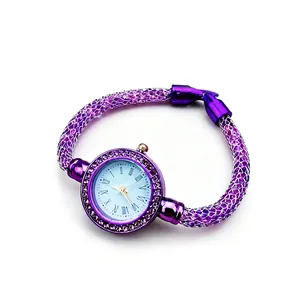 Detail of purple mesh bracelet watch featuring crystal-filled strap and rhinestone bezel