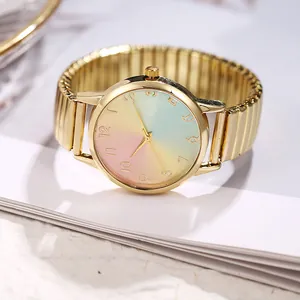 Macro view of gold metal elastic strap and macaron gradient dial on student watch