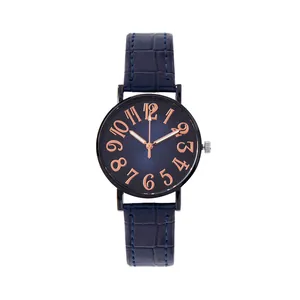 Detail of navy blue gradient watch dial with rose gold numerals and leather strap