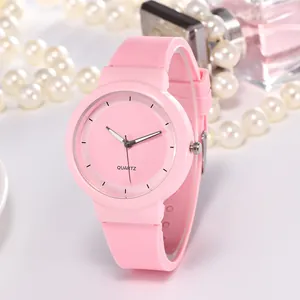 Pink minimalist quartz watch with silicone strap displayed with elegant fashion accessories