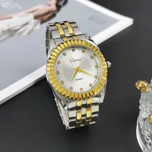 Detailed shot of two-tone stainless steel watch with golden fluted bezel and silver sunray dial