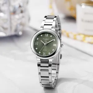 Detail of silver steel watch with emerald green sunray dial and crystal hour markers