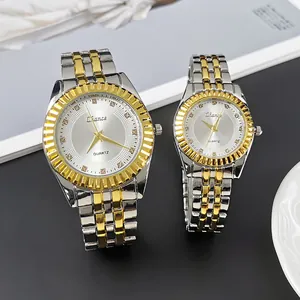 Detailed close-up of a luxury silver and gold steel quartz couple watch set on magazine