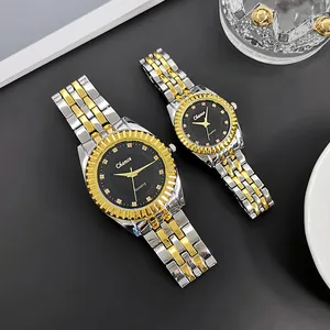 Close-up of gold and silver couple watches with black sunray dials and metal straps