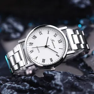 Macro shot of silver quartz watch with Roman numerals on a dark stone background