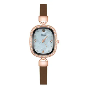 Close-up of vintage oval rose gold watch with diamond bezel and blue marble dial