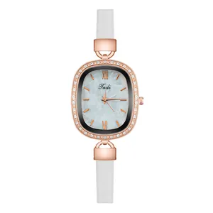 Detailed macro view of the oval rose gold watch case with crystal-set bezel and marble dial