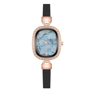 Macro detail of oval rose gold watch with sparkling crystals and marble blue dial