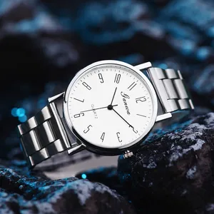 Detailed macro of a silver stainless steel quartz watch with a white minimalist dial