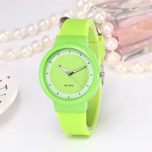 Macro detail of vibrant lime green quartz watch with soft silicone strap and matching dial